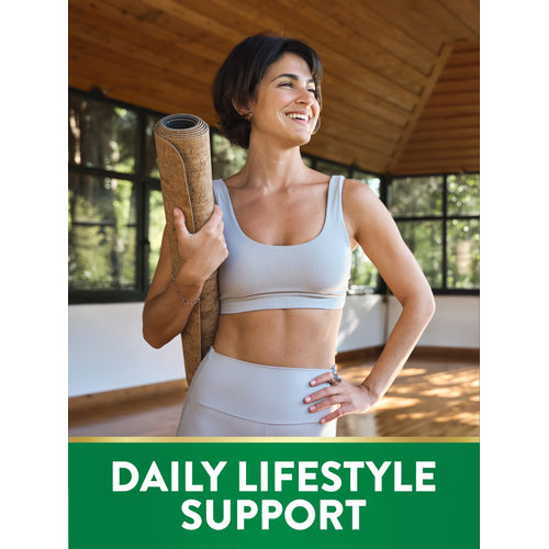 A woman smiles while holding a yoga mat and wearing athletic wear, representing NT Iron.