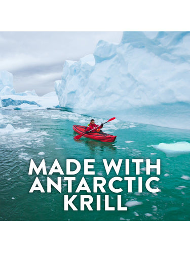 A person in a red kayak paddles in turquoise water with ice floes and large icebergs. Text: 'MADE WITH ANTARCTIC KRILL'.