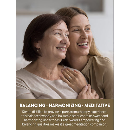 View 4 Two smiling women embracing, with text overlay: BALANCING • HARMONIZING • MEDITATIVE. Cedarwood's empowering and balancing qualities.