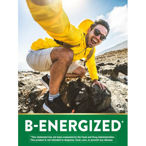 Young adult male in yellow jacket climbing outdoors, smiling energetically, with B-ENERGIZED text graphic.