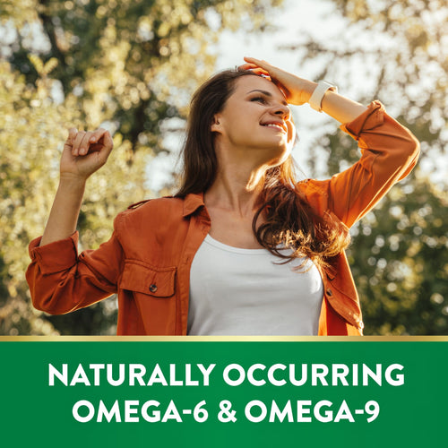 Young adult woman smiling outdoors, looking up, with NT Blackseed Oil. Green banner displays: NATURALLY OCCURRING OMEGA-6 & OMEGA-9.