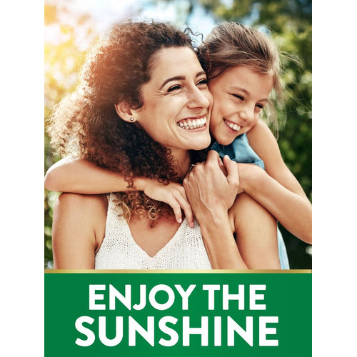 A smiling woman and young girl hugging outdoors under the sunshine, creating a warm, joyful scene.
