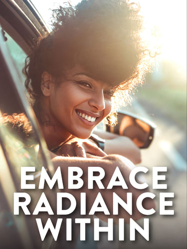 A young woman smiles and looks out of a car window into bright sunlight.
