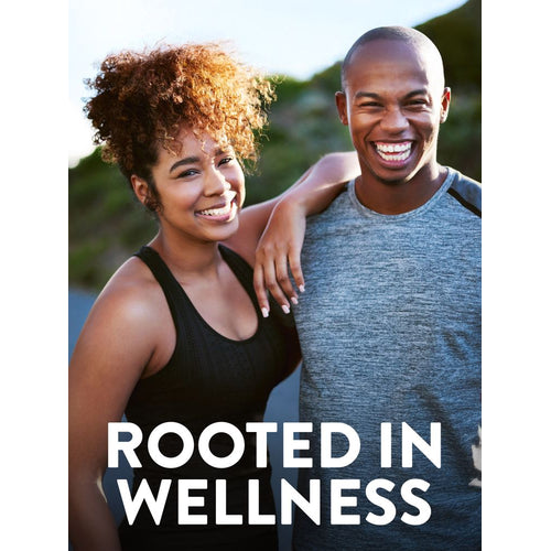 Smiling young woman and man in athletic wear outdoors, woman's arm on man's shoulder. Text: 'ROOTED IN WELLNESS'.