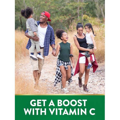 A family of five hiking outdoors in nature. Text banner: GET A BOOST WITH VITAMIN C.