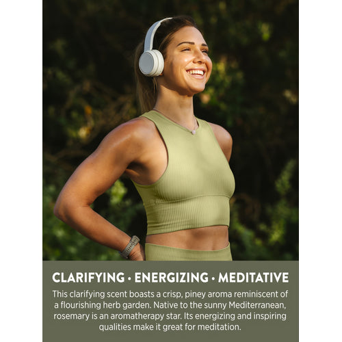 Woman smiling outdoors with text: Clarifying, Energizing, Meditative. Rosemary scent is crisp, piney, Mediterranean.
