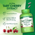 Pink quick release capsules with 7,000 mg equivalent of Tart Cherry Extract per serving, shown on a hand scale.