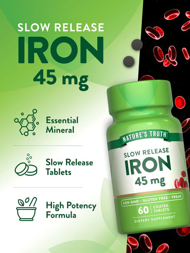 Dark grey, slow-release Iron 45 mg coated tablets on a hand-held scale for precise weight measurement.