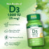 A hand holding two D3 1,000 IU (25 mcg) softgels, showcasing their size.
