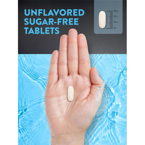 A hand holds an unflavored sugar-free tablet, measuring about 5/8 inch long.