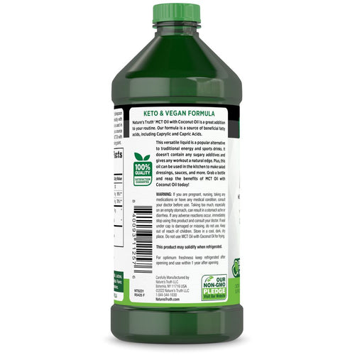 Hand holding NT MCT Oil Liquid 16 FL OZ bottle, back label showing product details and warnings.