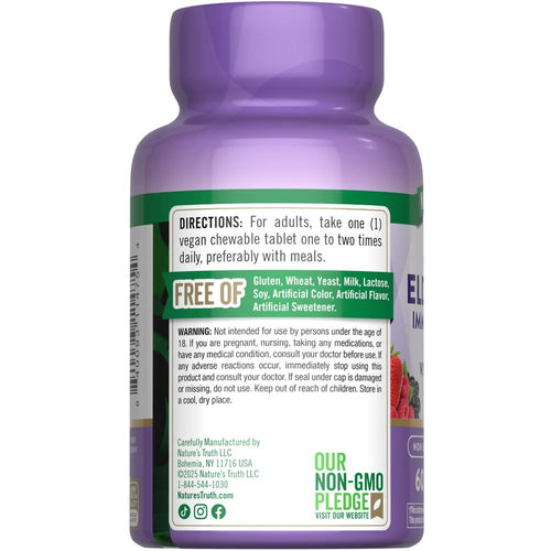 A hand holds a vegan chewable tablet with Elderberry, Vitamin C, and Zinc.